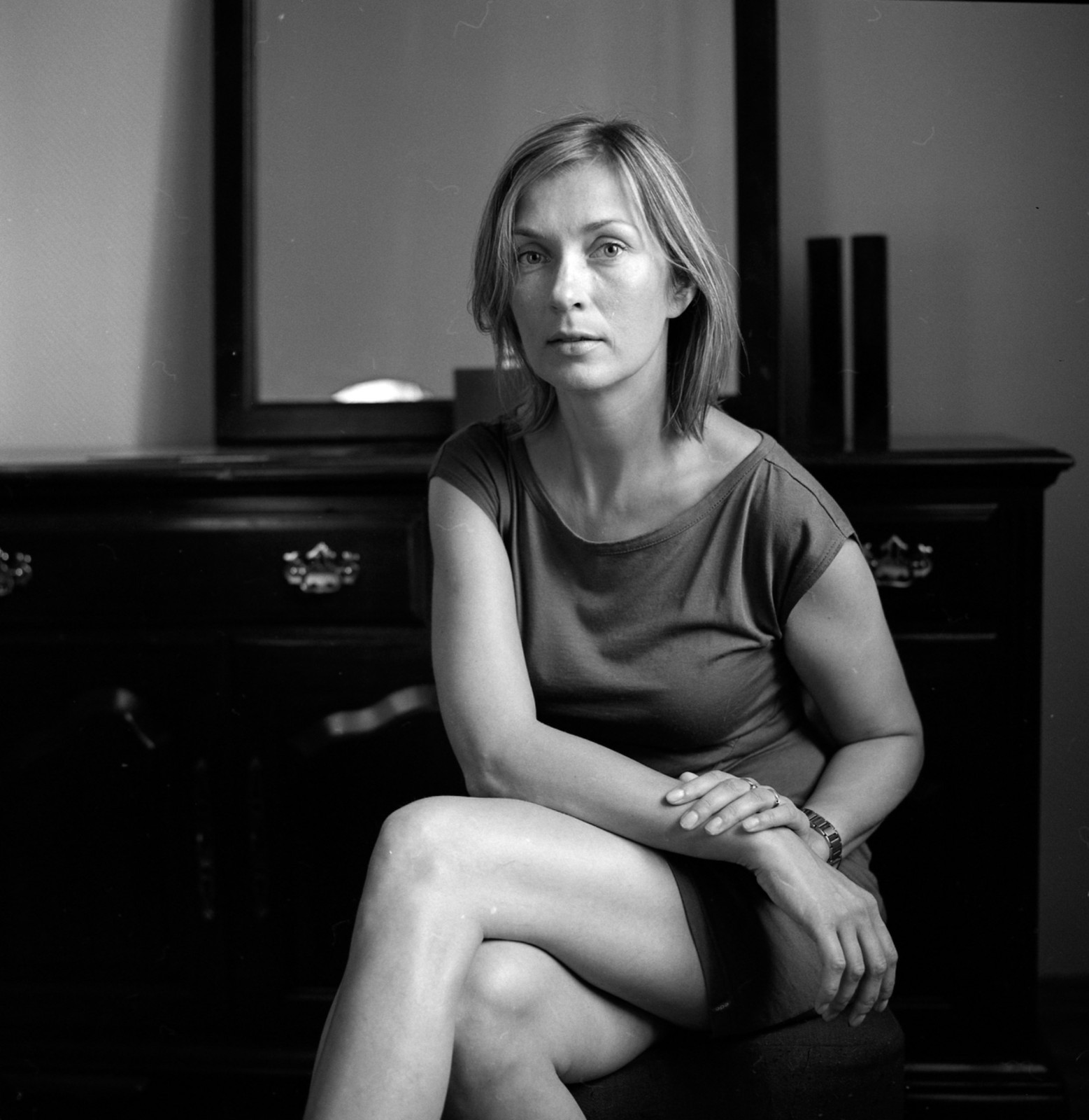 Seated portrait beside a piano