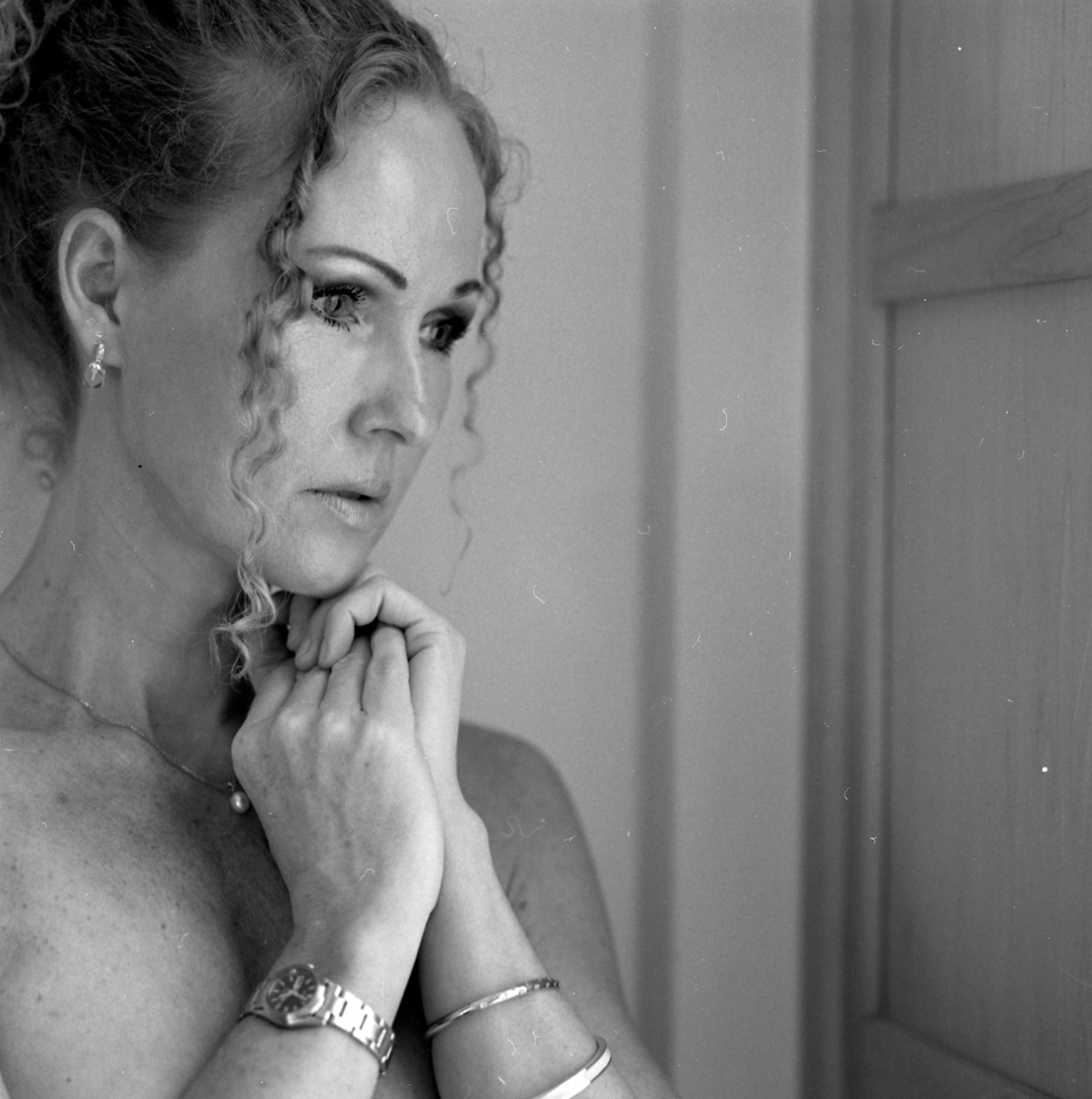 Reflective close portrait with hands together